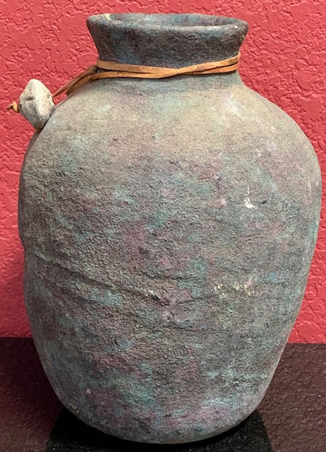 No. 18 Artifacts - Stone pottery Water Jar with Leather String. The String Wraps Around Neck With a Little Rock